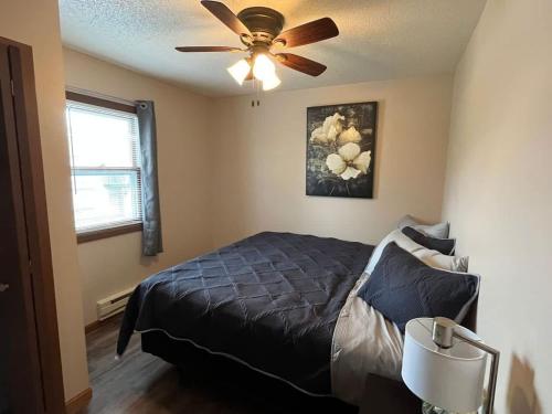 a bedroom with a bed and a ceiling fan at 201 E Veterans Street Apt B in Tomah
