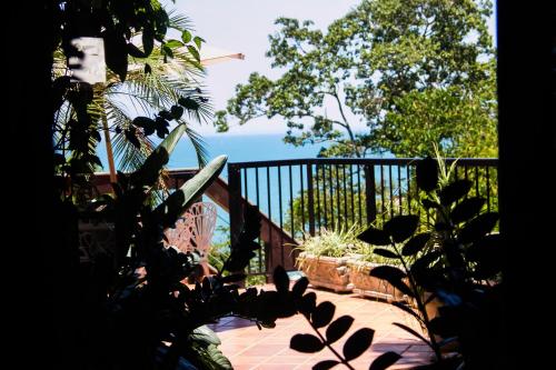 a view of the ocean from a balcony of a house at Pousada da Mata in Iriri