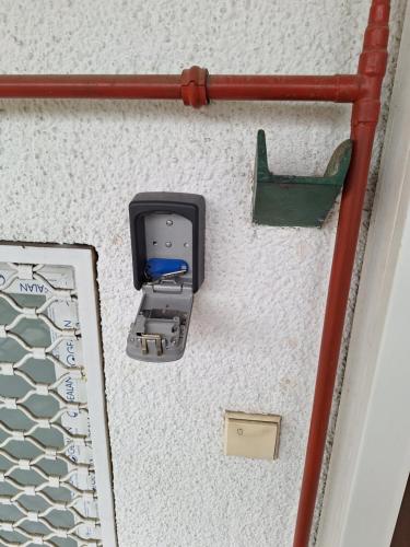 a lego phone on a wall with a green holder at Novi Sad CENTAR 6A in Novi Sad