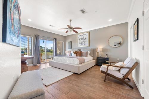 a bedroom with a bed and a couch and a chair at The Oasis on Lake Hamilton with Pool in Hot Springs