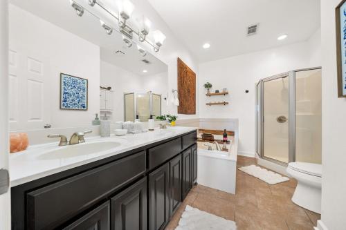 a bathroom with a sink and a shower and a toilet at The Oasis on Lake Hamilton with Pool in Hot Springs