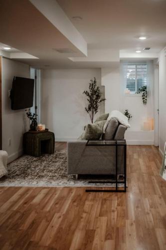 a living room with a couch and a television at The Barrie Nook in Barrie