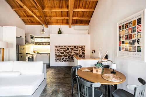a kitchen and dining room with a table and chairs at Rock Solid Stone House - Chora Samothraki in Samothraki