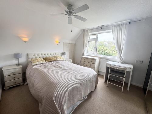 a white bedroom with a bed and a window at 3 Bed with parking, ideal for families in Marlow