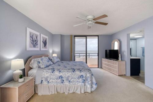 a bedroom with a bed and a ceiling fan at Paradise on the beach with pool in Daytona Beach