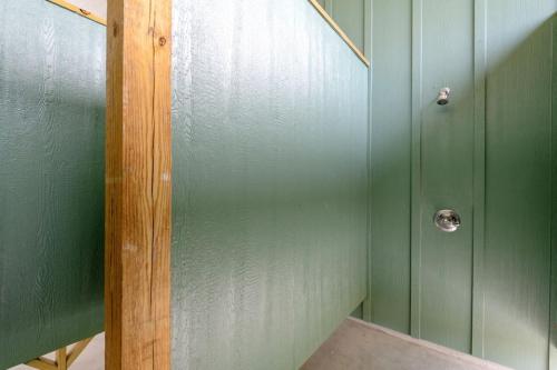 a shower with a glass door in a bathroom at Two Adjacent Cabins, Sleeps 18 in Bolivar Peninsula