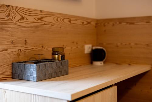 a counter in a room with a wooden wall at SAN PIETRO DOLOMITI Small Budget Hotel in Ortisei