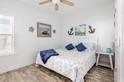 a bedroom with a bed with blue pillows at Gulf View 3BR 2BA Steps to Beach 2 King Beds in Bolivar Peninsula