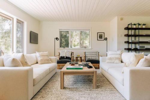 a living room with two white couches and a coffee table at Catskills Arthouse - 15 mins to Skiing in Margaretville