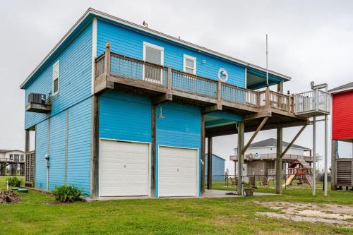 a blue house with a deck on top of it at Gulf View 3BR 2BA Steps to Beach 2 King Beds in Bolivar Peninsula