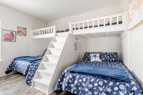 a bedroom with two beds and a bunk bed at Gulf View 3BR 2BA Steps to Beach 2 King Beds in Bolivar Peninsula