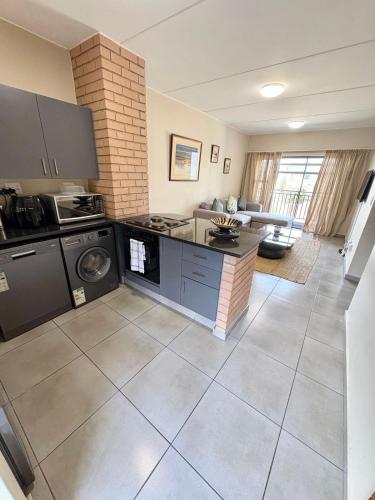 a kitchen with a washer and dryer in a room at The Place at Mall of Africa 2 in Midrand