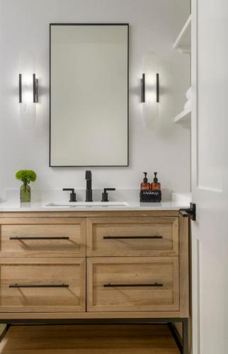 a bathroom with a sink and a mirror at Private Balcony and Coastal Escape in Summerland