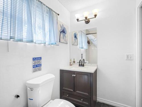 a bathroom with a toilet and a sink at Spacious Stay, Family Comfort, Quiet Escape in Plant City