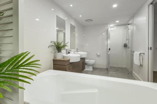 克瓦拉海滩Kewarra Beach Studio Apt with Resort Pool and BBQ的带水槽和马桶的白色浴室
