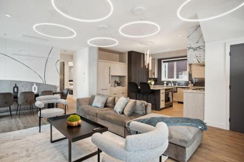 a living room with a couch and a table at Luxury Downtown Vancouver Home Near Sunset Beach with Parking in Vancouver