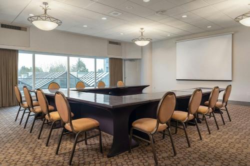 a conference room with a large table and chairs at Sheraton Vancouver Guildford Hotel in Surrey