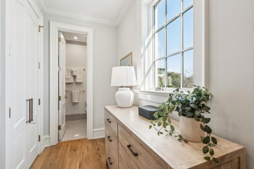a room with a table with a lamp and a window at New Build - Steps to King Street in Charleston
