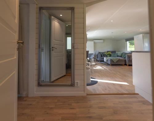 a hallway with a mirror and a living room at Hjärnarp in Hjärnarp
