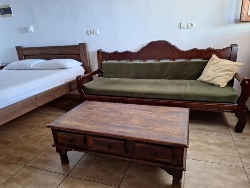 a room with two beds and a couch and a coffee table at Kastania Gi in Palaios Panteleimon