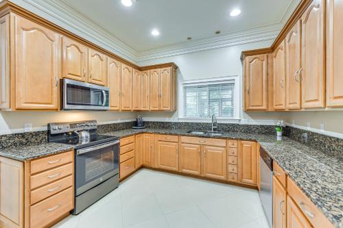 a kitchen with wooden cabinets and granite counter tops at 5 Mi to Beach Spacious Home on Hilton Head Island in Hilton Head Island