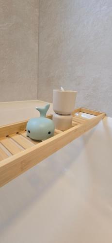 a wooden tray with a vase and other items on it at RINGZEIT-Lodge in Herresbach