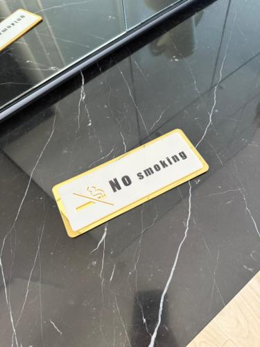 a no smoking sign on the front of a car at Duplex sur le Golfe de Saint Tropez - Panoramic View in Cogolin