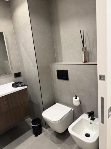 a bathroom with a white toilet and a sink at Duplex sur le Golfe de Saint Tropez - Panoramic View in Cogolin