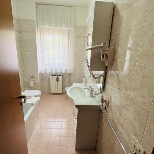 a bathroom with a sink and a toilet at Appartamento Antonietta- in Santa Maria degli Angeli