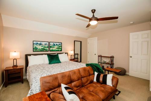 a bedroom with a bed and a couch at 1 Mi to Dtwn Black Mountain Home with Patio and Yard in Black Mountain
