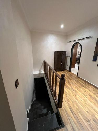a staircase in a house with a wooden floor at Entre Medina et Mer Duplex in Rabat
