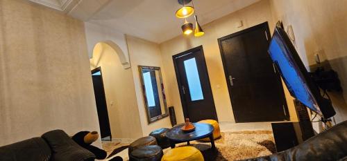 a living room with a couch and a flat screen tv at Apprtoment 70m in Hajreien
