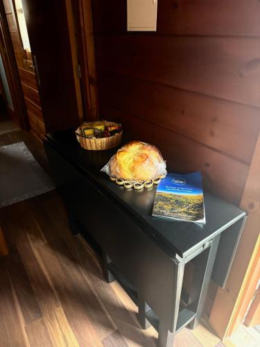 a table with a loaf of bread and a book on it at Bungalow da Pedreira in Viseu
