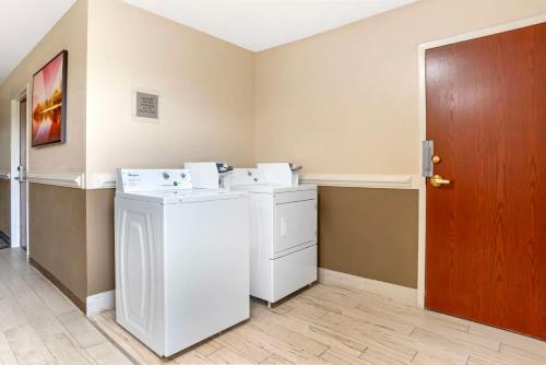 a washer and dryer in a room with a door at Best Western Gardendale in Gardendale