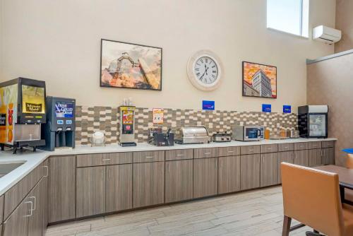 a coffee shop with a clock on the wall at Best Western Gardendale in Gardendale