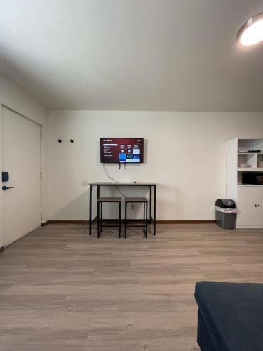 a room with a table and a tv on a wall at Unit 10 - Stand Rock Studios in Wisconsin Dells