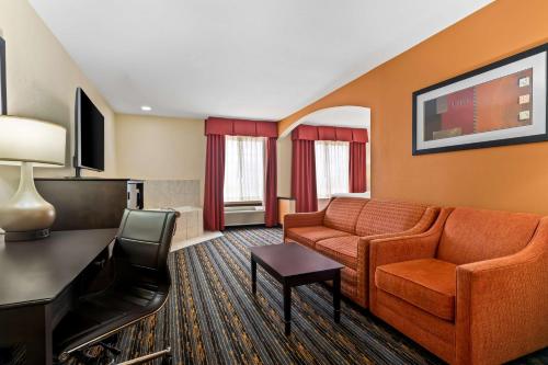 a living room with a couch and a tv at Best Western Kenosha Inn in Broken Arrow