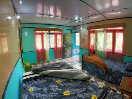 a small room with a bed and a couch at Sisney River Retreat in Rongli