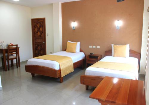 Postel nebo postele na pokoji v ubytování Hotel Flamingo