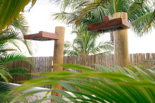 two wooden crosses in front of a wooden fence at Café Jeri Hotel - Adults Only in Jericoacoara