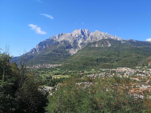a view of a mountain with a town in front of it at Le Rive nel bosco in Capo di Ponte
