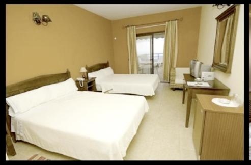 Cama o camas de una habitación en Hotel Villa El Mocanal