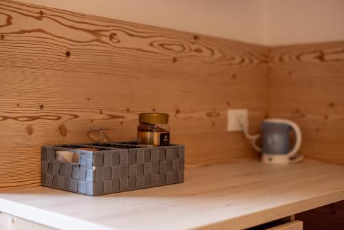 a kitchen counter with a coffee pot on a table at SAN PIETRO DOLOMITI Small Budget Hotel in Ortisei