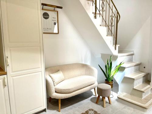 a living room with a chair and stairs at Charming of Olhão in Bicas