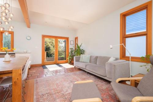 a living room with a couch and a table at Cozy Heritage Home Near Main St in Vancouver
