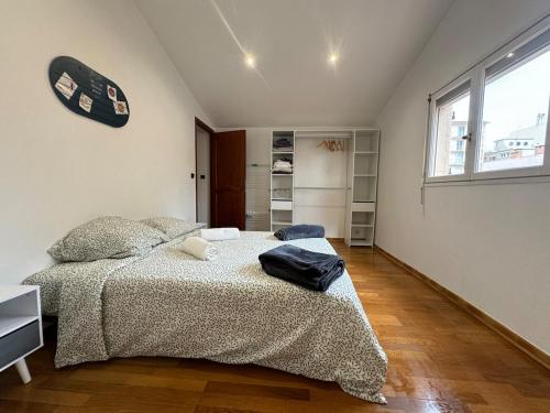 a bedroom with a bed and a large window at Chez Zelie in Canet-en-Roussillon