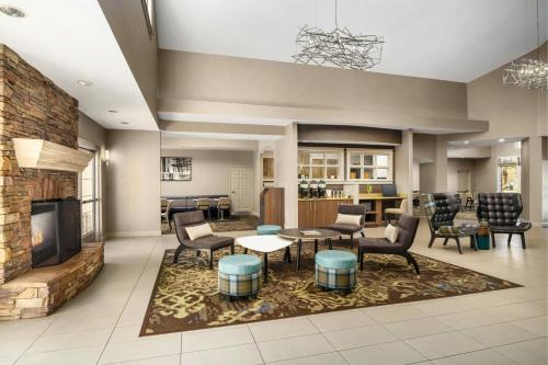 a lobby with a living room with chairs and a fireplace at Residence Inn By Marriott Las Vegas Stadium Area in Las Vegas