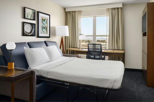 a hotel room with a bed and a desk at Residence Inn By Marriott Las Vegas Stadium Area in Las Vegas