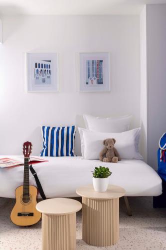 a teddy bear sitting on a couch in a living room at Seb & Co in Paris