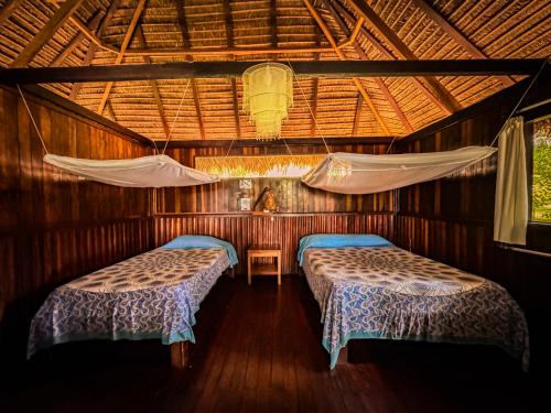 Postel nebo postele na pokoji v ubytování Corto Maltes Amazonia Lodge